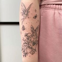 a woman's arm with flowers and butterflies tattooed on the left side of her body