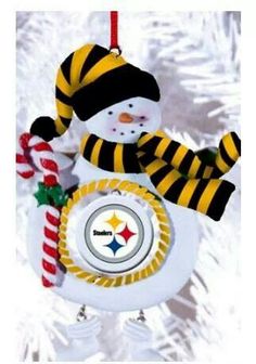 a snowman ornament hanging from a christmas tree with the pittsburgh football team on it