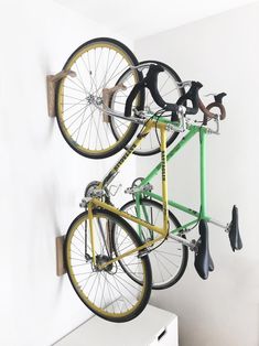 there are two bikes hanging on the wall