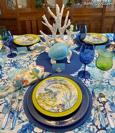 a table set with blue and green plates