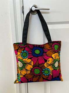 These tote bags, crafted from vibrant African Ankara fabrics, feature sturdy straps for comfortable carrying. They offer ample space for your essentials and are perfect for everyday use or special occasions. The bold and colorful patterns of the Ankara fabric make each bag a unique statement piece, blending functionality with cultural elegance. 100% African wax cotton  Lined with black felt Black fabric straps Retro Multicolor Tote Hobo Bag, Colorful Tote Shoulder Bag For Market, Retro Multicolor Hobo Tote Bag, Multicolor Square Hobo Bag For Travel, Everyday Reversible Multicolor Hobo Bag, Large Multicolor Bags For Daily Use, Multicolor Rectangular Hobo Bag Gift, Multicolor Fabric Shoulder Bag With Double Handle, Eco-friendly Large Capacity Multicolor Canvas Bag