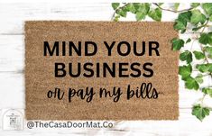 a door mat that says, mind your business on pay my bills