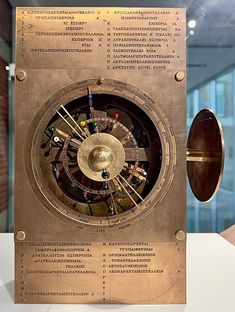 an old clock that is on display in a museum or office building with information about the time