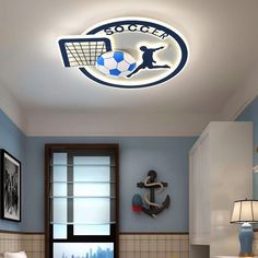 a room with blue walls and a white ceiling has a soccer theme on the wall