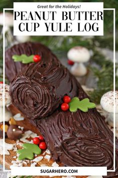 a piece of chocolate cake sitting on top of a wooden cutting board with holly leaves