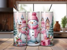 two snowmen are standing next to each other in front of a christmas themed coffee mug