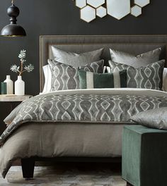 a bedroom with black walls and grey bedding