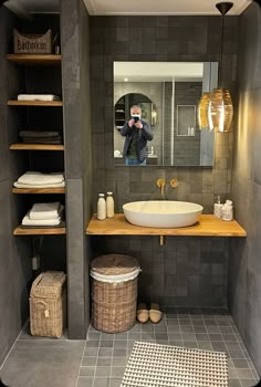 a bathroom with a sink, mirror and shelves