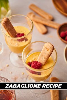 two glasses filled with desserts sitting on top of a table next to cinnamon sticks