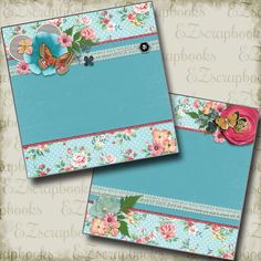 two blue envelopes with pink flowers and butterflies on them, one has a flower in the middle