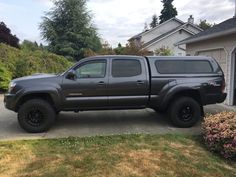 a gray truck parked in front of a house