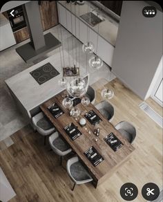 an aerial view of a dining room table and chairs in the middle of a kitchen