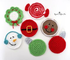 crocheted christmas ornaments are arranged on a white surface, including a santa clause or snowman