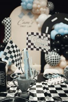 a black and white checkered table cloth with some paper flags on top of it