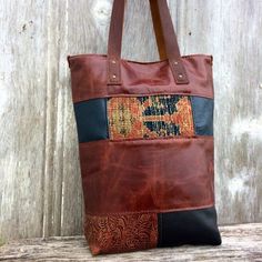 Leather Patchwork Carpetbag Tote in Distressed Chestnut and Black Color Block with Antique Rug, Handmade, OOAK Gift for Her,  by Stacy LeighOne of a kind, handmade, leather tote made with hand-sewn leather "patches" and antique carpet.  The antique carpet was part of a Persian rug and is worn and faded.   The bag is in a variety of embossed brown, and black leathers.   The patchwork is all sewn by hand by Morgan.  Fully lined in a light brown herringbone fabric and brown leather with 5 leather p Black Patchwork Shoulder Bag For Everyday Use, Brown Hand-stitched Tote Shoulder Bag, Brown Hand-stitched Bag For Daily Use, Artisan Black Bag With Leather Handles, Artisan Black Bags With Leather Handles, Everyday Brown Patchwork Shoulder Bag, Brown Patchwork Rectangular Bag, Brown Rectangular Patchwork Bag, Rectangular Brown Patchwork Bag