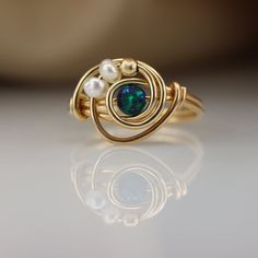 There is nothing ordinary about this handmade wrap ring. Set with a beautiful Atlantic Opal that goes well with any outfit. ☆ WHY THIS PIECE OF J E W E L R Y IS AWESOME! ☆ * Hand finished and made from high quality raw materials * Long lasting beauty & Timeless design * Set with a Atlantic Opal 5 mm, Fresh water pearls and a gold plated bead ♡ WRAPPING ♡ * All 23 Summers jewels arrive in a cute pouch or gift box so they are gift ready. DELIVERY ✉ * Most items are ready made but some are made Cute Wire Rings, Bead Wrapping, Wire Jewelry Patterns, Wire Jewelry Rings, Wire Wrap Jewelry Designs, Ring Pearl, Ring Wire, Diy Jewelry Inspiration, Wire Jewelry Designs