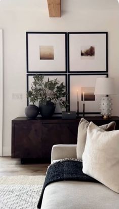 a living room filled with furniture and pictures on the wall