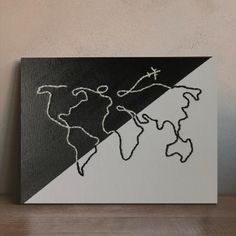 a black and white painting with a world map drawn on it