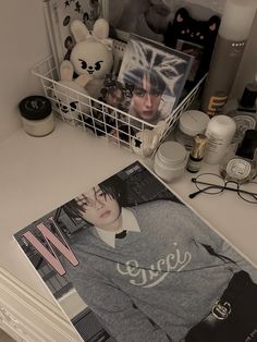 a magazine sitting on top of a white counter next to a basket filled with stuff