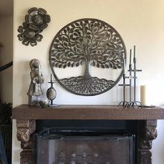 a fire place with a metal tree on the mantle