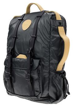 a black and tan backpack with brown straps