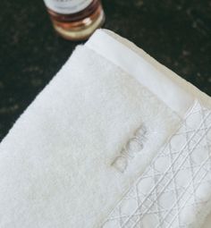 a white towel sitting on top of a counter next to a bottle