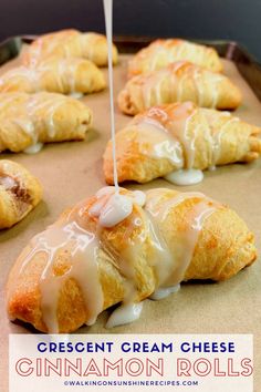 croissant cream cheese cinnamon rolls are being drizzled with icing