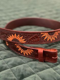 These ladies belts are hand tooled and created special for you. There is no buckle included, those can be added on for an extra fee if you prefer.  Send us a message upon purchasing with your color suggestions, length and customization. Hand Tooled Leather Belt Gift, Adjustable Hand-tooled Leather Belt, Hand Tooled Brown Belt For Gift, Adjustable Hand Tooled Belt Perfect For Gifts, Adjustable Hand Tooled Belt As Gift, Sunflower Belt, Ladies Belts, Western Leather Belt, Western Leather