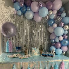 a table topped with balloons and cake