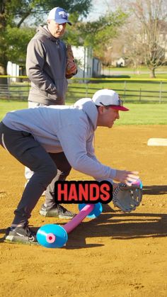 a man kneeling down on top of a baseball field