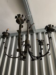 a metal chandelier hanging from the ceiling