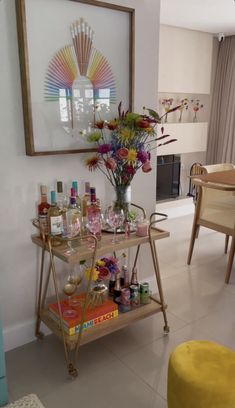 a bar cart filled with liquor bottles and flowers