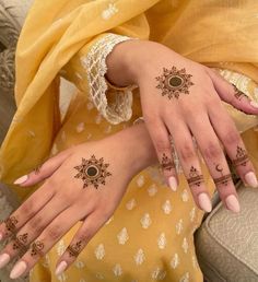 two women with henna tattoos on their hands