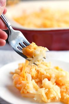 a person is holding a fork with some food on it