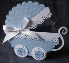 a blue and white baby carriage with a bow on it's head, sitting in front of a black background