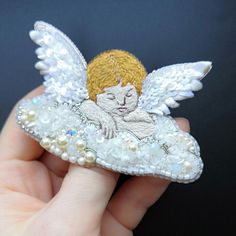 A brooch in the form of an angel. Embroidered with threads and beads. Very delicate work. The reverse side is smooth, covered with artificial white leather. You can see the reverse side of the brooch in the photo.You can wear this brooch on your clothes, scarf or bag.Size W7.3*H4.5(cm)Weight 6 g.Material felt, beads, artificial leather, brooch pin. Leather Brooch, Beautiful Stars, Angel Brooch, Angel Pin, Felt Beads, Beaded Brooch, An Angel, Artificial Leather, White Leather