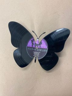 a butterfly shaped vinyl record with the words flesh lies on it's back side