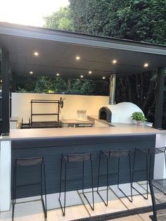 Looking to elevate your outdoor space? Check out our stunning outdoor kitchen design with a pizza oven! Create a stylish and functional area perfect for entertaining guests or enjoying family meals al fresco. Transform your backyard into a culinary oasis with this must-have addition. Outdoor Bar With Pizza Oven, Pizza Oven Bar, Outdoor Kitchen And Bar Design, Small Outdoor Kitchen And Bar, Grill Place Outdoor, Outdoor Bbq And Bar Ideas, Grill And Bar Outdoor, Outdoor Bbq Bar Ideas, Stone Pizza Oven Outdoor