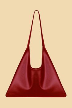 Elevate your style with the Agave Triangular Tote in Burgundy Red from Santos by Monica, but much larger. Made from plant-based Desserto cactus leather, this spacious tote is perfect for any occasion. Elegant Everyday Triangle Bag, Elegant Triangular Everyday Bag, Modern Triangle Bag For Everyday Use, Modern Triangle Bag For Everyday, Modern Everyday Triangle Bag, Modern Triangle Everyday Bag, Chic Triangle Shoulder Bag For Everyday Use, Chic Triangle Shoulder Bag For Everyday, Chic Everyday Triangle Shoulder Bag