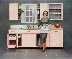 a woman standing next to a kitchen sink