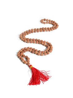 This set of Prayer Beads, a Mala or Rosary, is made of finely selected, peppercorn sized, five Mukhi Rudraksha mala beads. Thread-knotted in traditional style with red tassel, this Rudraksha rosary is best for doing Japa or chanting mantras to all deities. You may keep the healing mala in your puja altar for positive vibrations or as a garland for your deity idol. You may also wear it around your neck. It is best to avoid wearing this with other Rudraksha combinations. Measures 34 inches long wh Wooden Beads Mala For Rituals And Festivals, Traditional Hand-strung Mala For Meditation, Traditional Wooden Beads Mala For Puja, Traditional Mala With Wooden Beads For Puja, Red Beaded Mala For Meditation, Red Mala For Meditation, Traditional Hand-strung Mala For Festivals, Traditional Hand Knotted Mala For Meditation, Traditional Hand Knotted Mala For Rituals