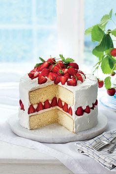 a chocolate cake with strawberries and whipped cream