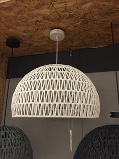 two white wicker lamps hanging from the ceiling