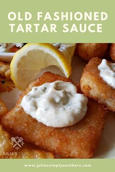 some fried food is on a plate with lemon wedges