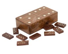 a wooden box filled with dices sitting on top of each other next to it