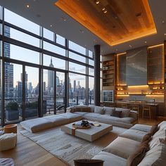 a living room filled with lots of furniture and large windows overlooking the cityscape