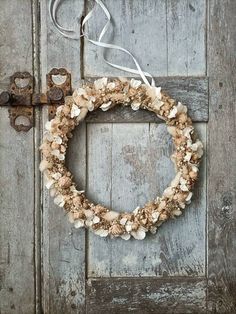 an old door with a wreath hanging on it