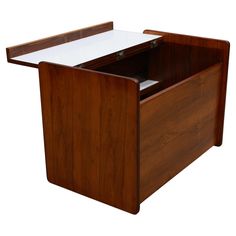 a wooden desk with a white top and drawers