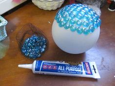 an egg with beads and glue next to it