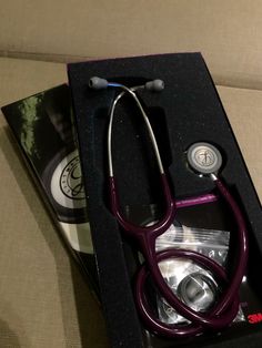 a purple stethoscope sitting in a black box